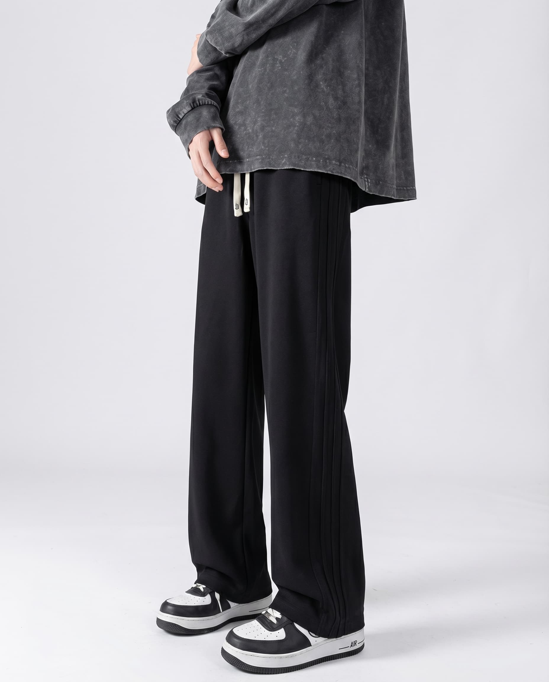 Black cotton straight leg sweatpants side view on tall model