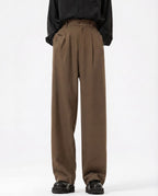 Tall men's brown crinkle trousers, front view showing relaxed straight-leg silhouette
