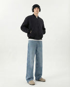 Tall man in relaxed fit jeans paired with black hoodie, full outfit