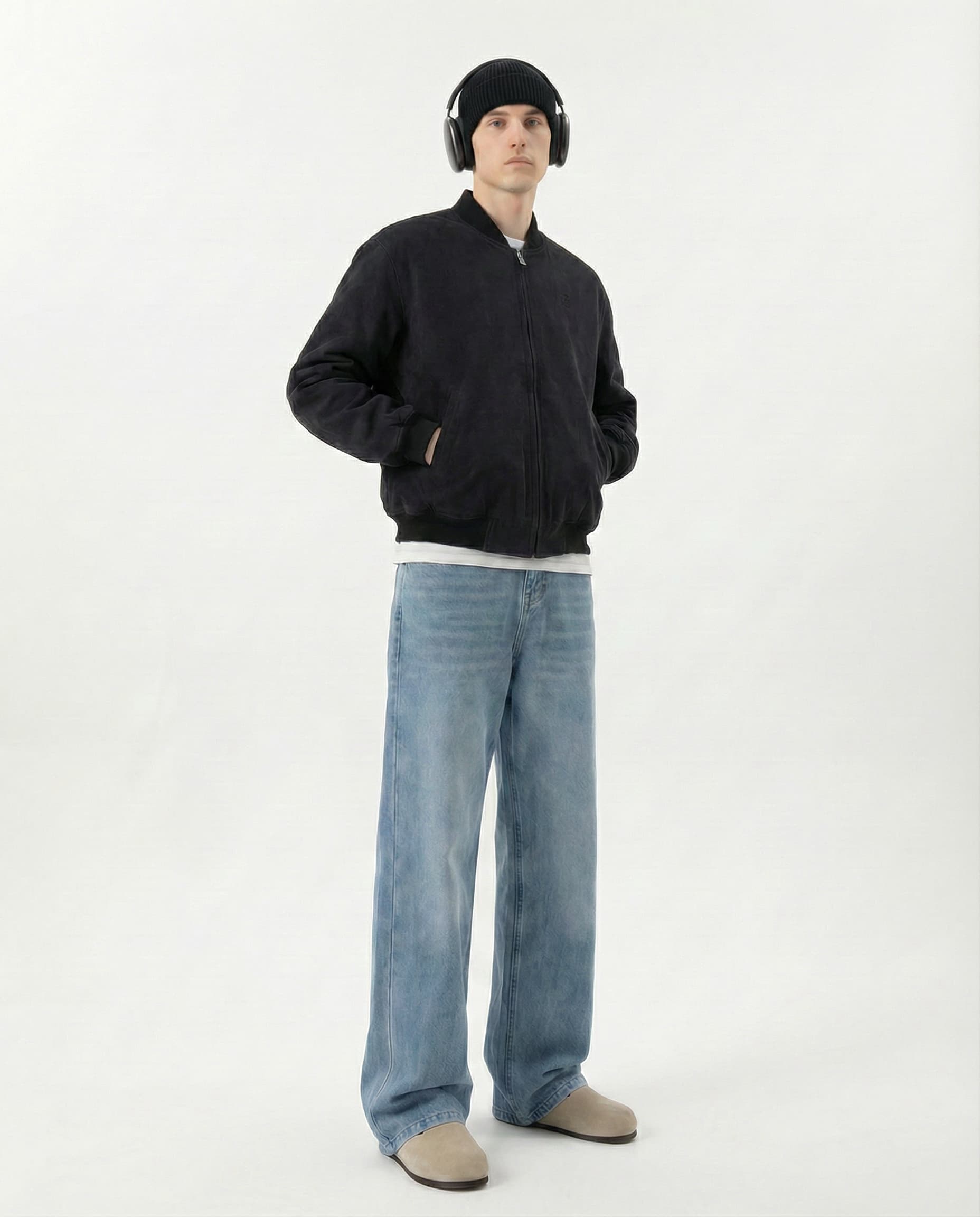 Tall man in relaxed fit jeans paired with black hoodie, full outfit