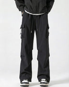 A tall man wearing black straight fit vintage cargo pants, front view full length
