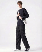 Tall man stretching in black straight fit vintage cargo pants showing flexibility and fit
