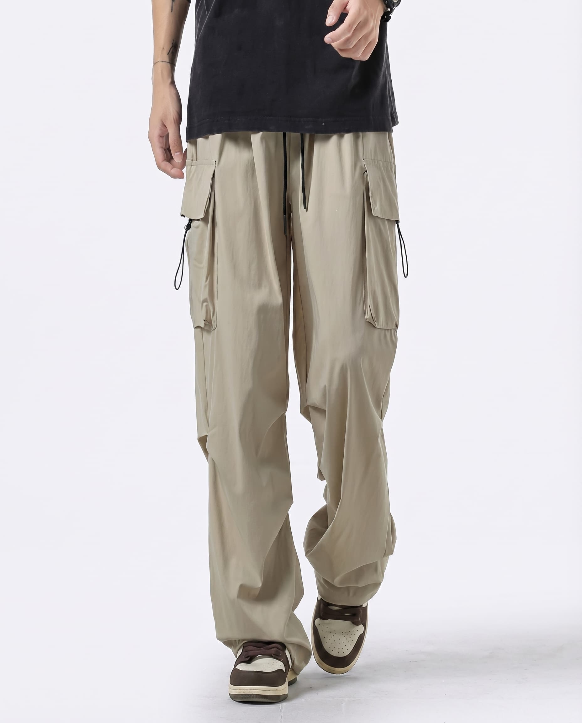 A tall man wearing khaki straight fit vintage cargo pants, front view full length