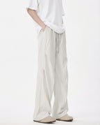 Close-up detail of white breezy wide-leg pants for tall men, fabric texture
