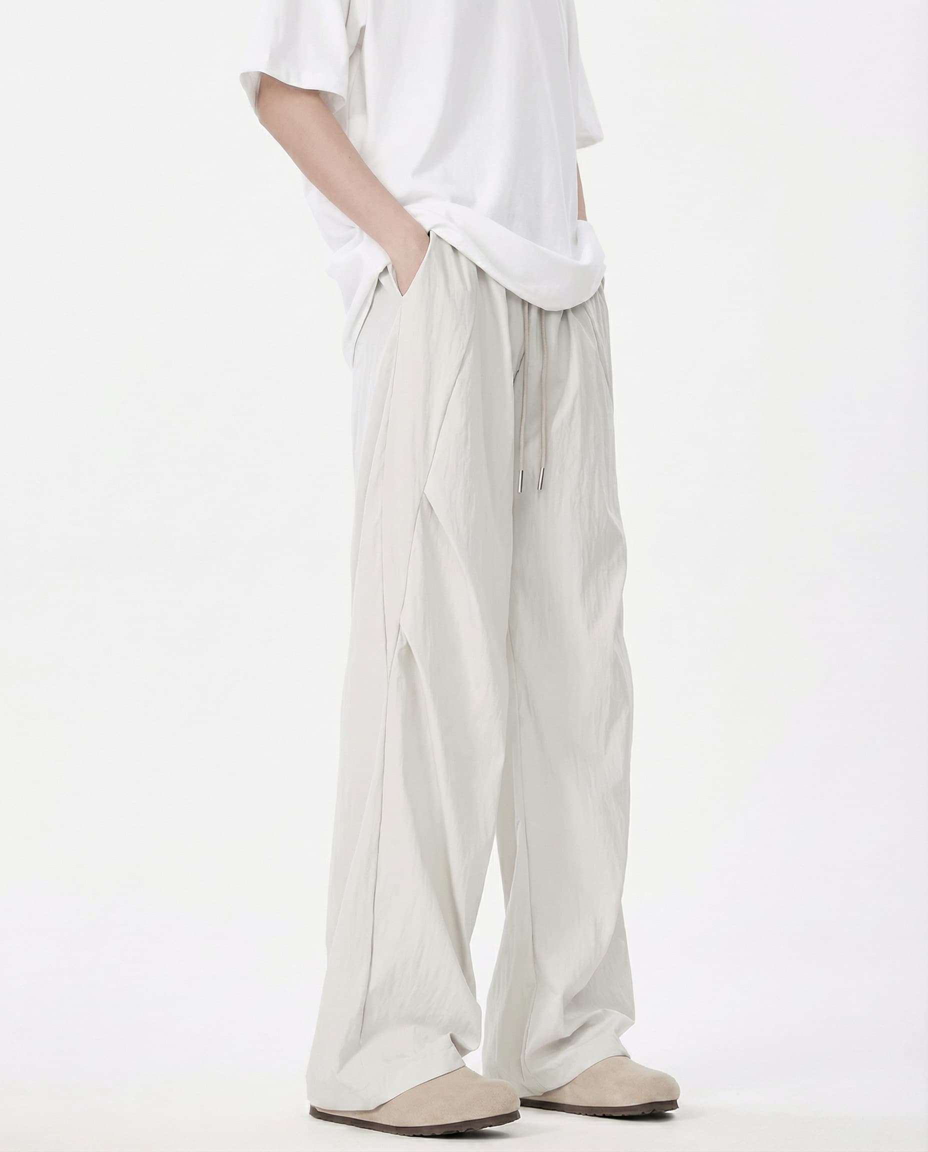 Close-up detail of white breezy wide-leg pants for tall men, fabric texture
