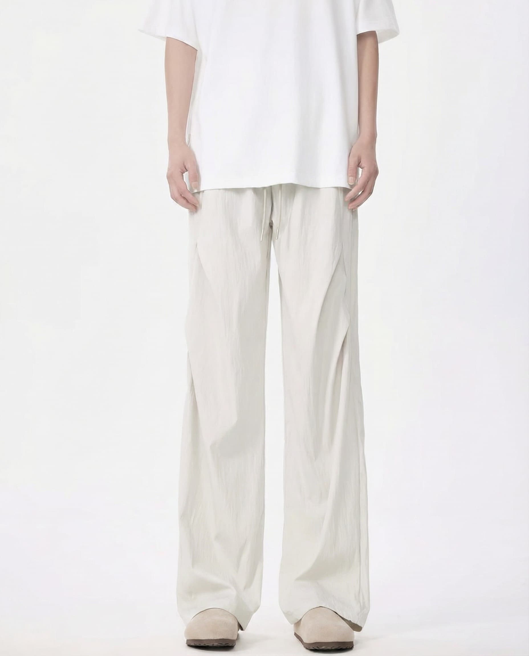 White breezy wide-leg pants for tall men, front view with minimalist clean aesthetic
