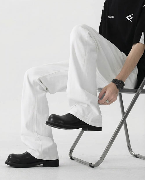 Tall men's white straight-leg jeans, seated pose showing comfort and relaxed fit