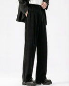 Men's black crinkle trousers in relaxed straight fit, styled with oversized jacket
