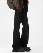 Black mid rise flare jeans for tall men, full-length view styled with brown bomber jacket