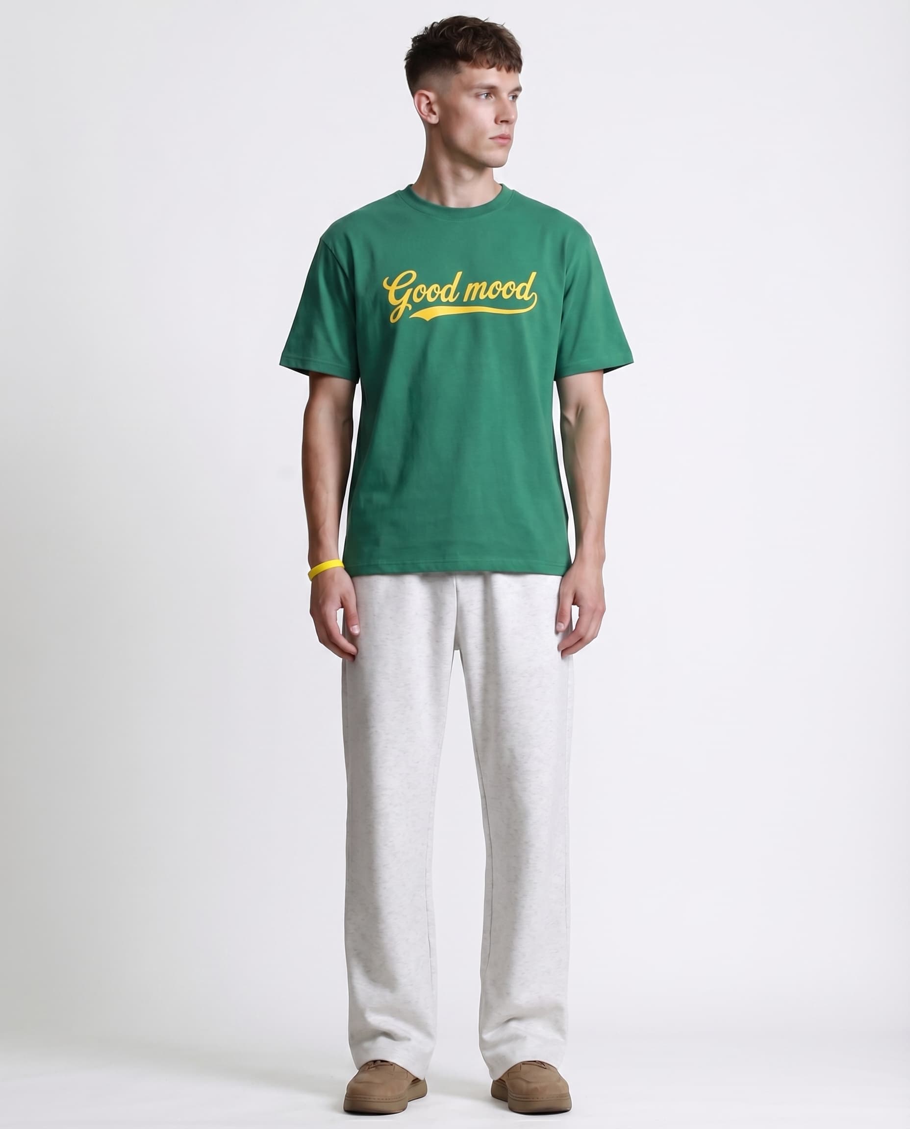 White straight leg sweatpants for tall men styled with green tee, casual color-block outfit look