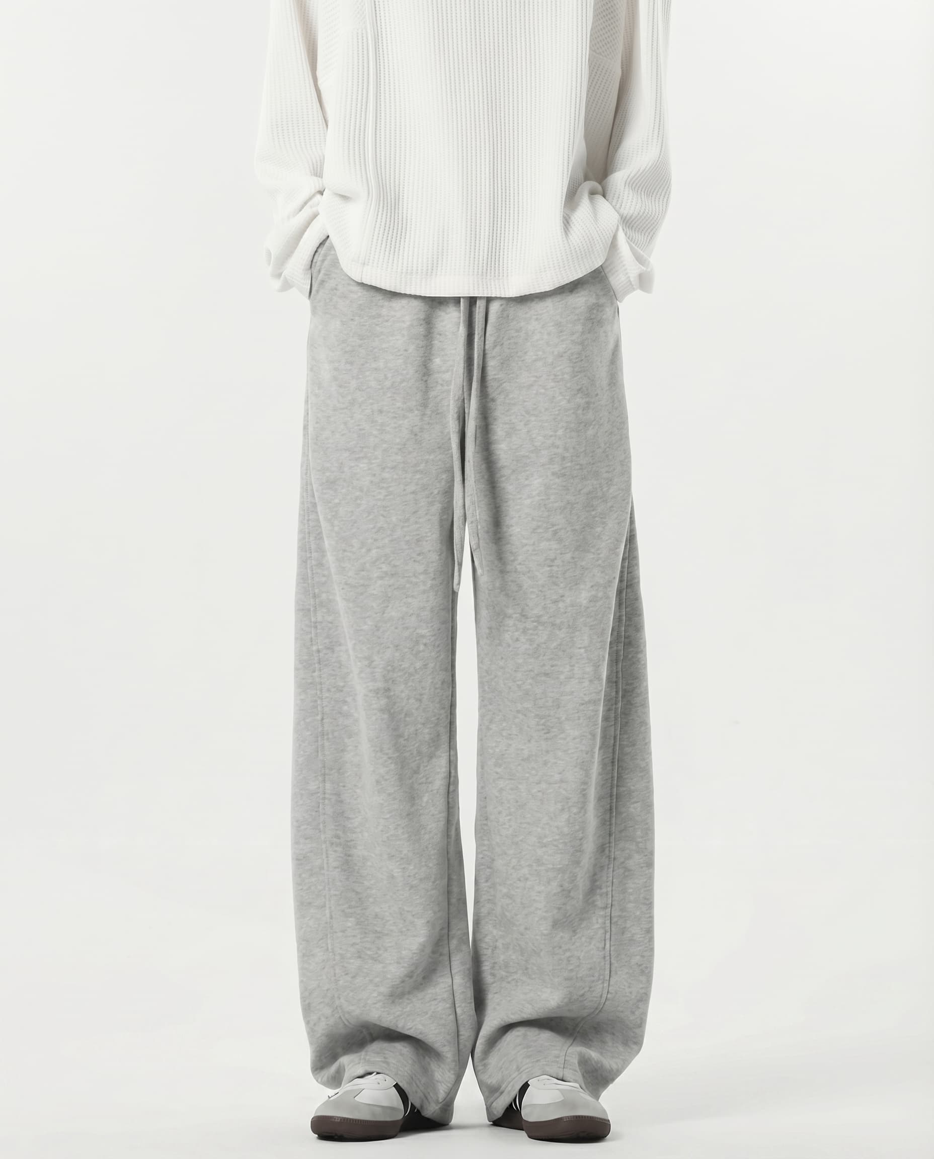 Tall men's gray stretch lounge sweatpants, front view showing wide-leg silhouette and full length