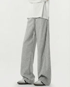 Tall men's gray lounge sweatpants, side profile highlighting stretch fabric drape and leg width