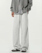 White weekender stretch lounge sweatpants for tall men, front view showing relaxed wide-leg silhouette
