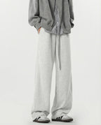 White stretch lounge sweatpants for tall men styled with brown jacket, layered casual outfit look