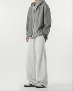 Close-up hem detail of white weekender sweatpants for tall men, wide leg opening and fabric drape