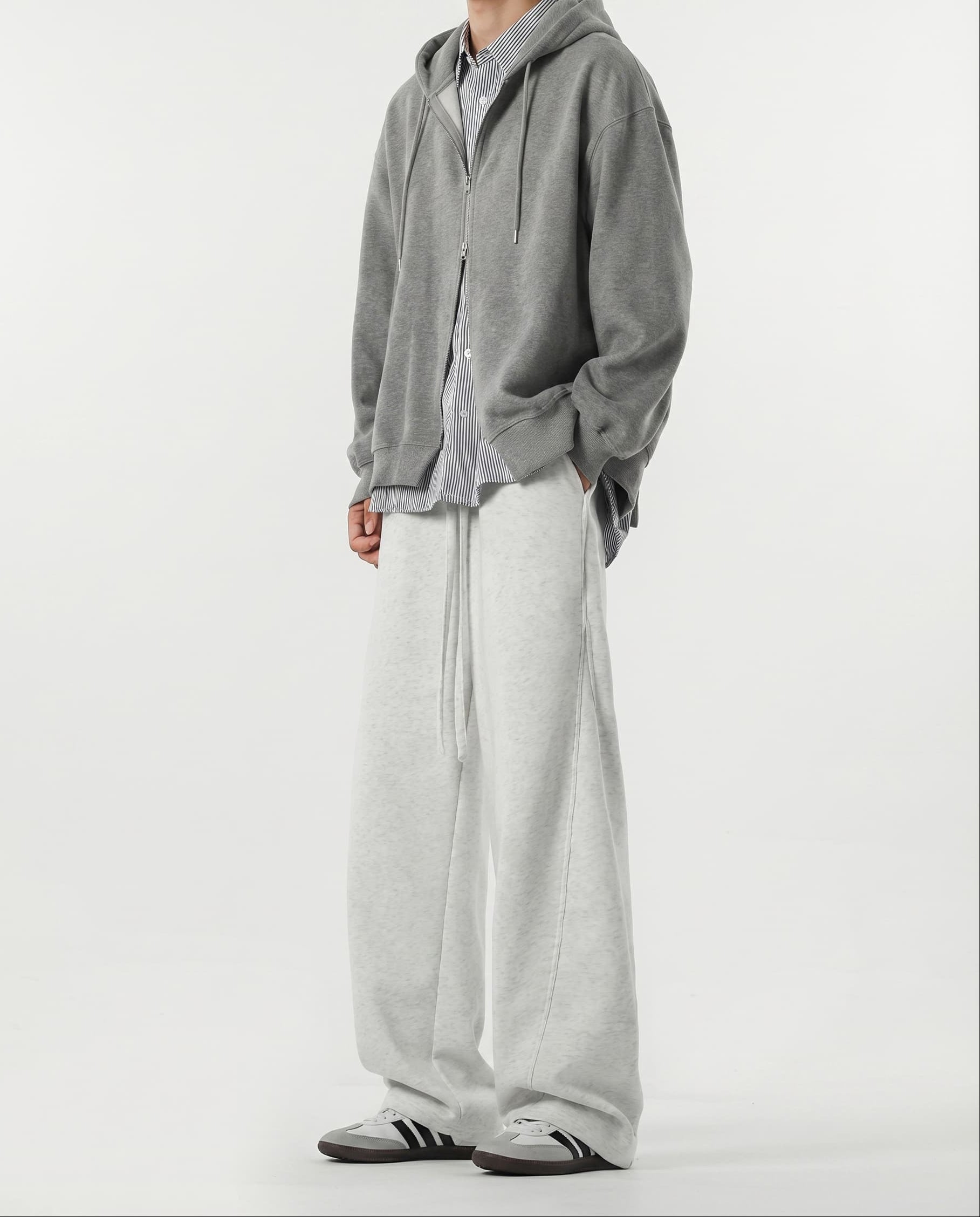 Close-up hem detail of white weekender sweatpants for tall men, wide leg opening and fabric drape